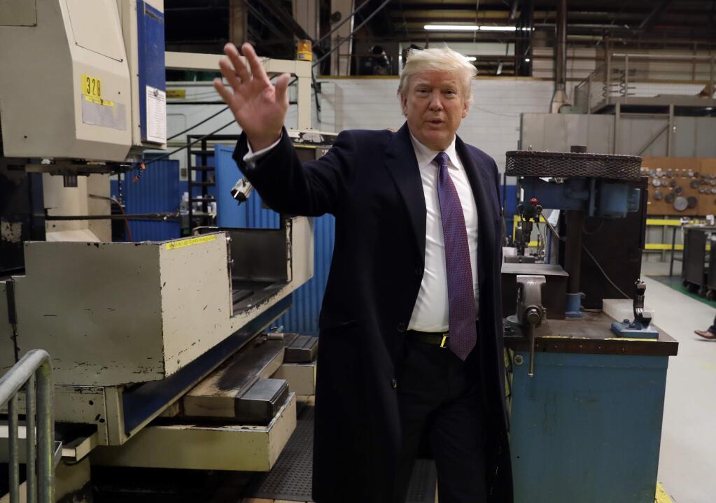 President Donald Trump waves as he participates in a tour of Sheffer Corporation to promote his tax policy, Monday, Feb. 5, 2018, in Cincinnati. (AP Photo/Evan Vucci)
