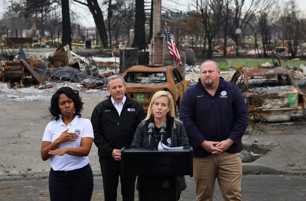 U.S. Homeland Security secretary Kirstjen Nielsen addresses the media during a press conference on View Court, in the Coffey Park area of Santa Rosa, with Federal Emergency Management Agency Region IX administrator Robert J. Fenton, Jr., right, and California Governor's Office of Emergency Services director Mark Ghilarducci, on Wednesday, January 3, 2018. (Christopher Chung/ The Press Democrat)