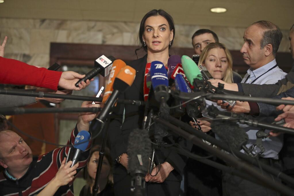 Former Russian pole vaulter Yelena Isinbayeva speaks to the media in Moscow, Russia, Friday, Dec. 9, 2016. Pole vault great Yelena Isinbayeva says she will oppose blanket bans of Russian athletes after being named the head of the suspended Russian anti-doping agency's new supervisory board. (AP Photo/Pavel Golovkin)