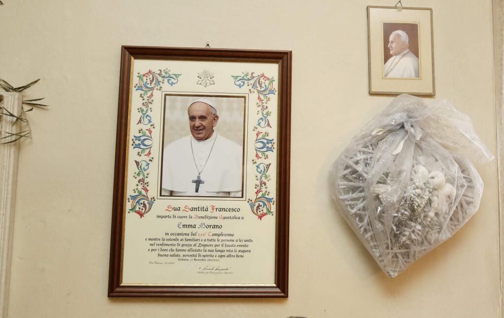 A parchment with papal blessing hangs on a wall in Emma Morano's home in Verbania, Italy on Tuesday, Nov. 29, 2016. (AP Photo/Antonio Calanni)