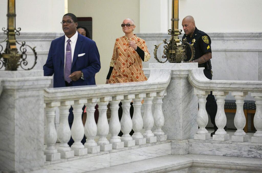 Camille Cosby, center, walks down the hallway towards the courtroom at the Montgomery County Courthouse, in Norristown, Pa., for her husband Bill Cosby's sexual assault trial, Tuesday, April 24, 2018. (Jessica Griffin/The Philadelphia Inquirer via AP)