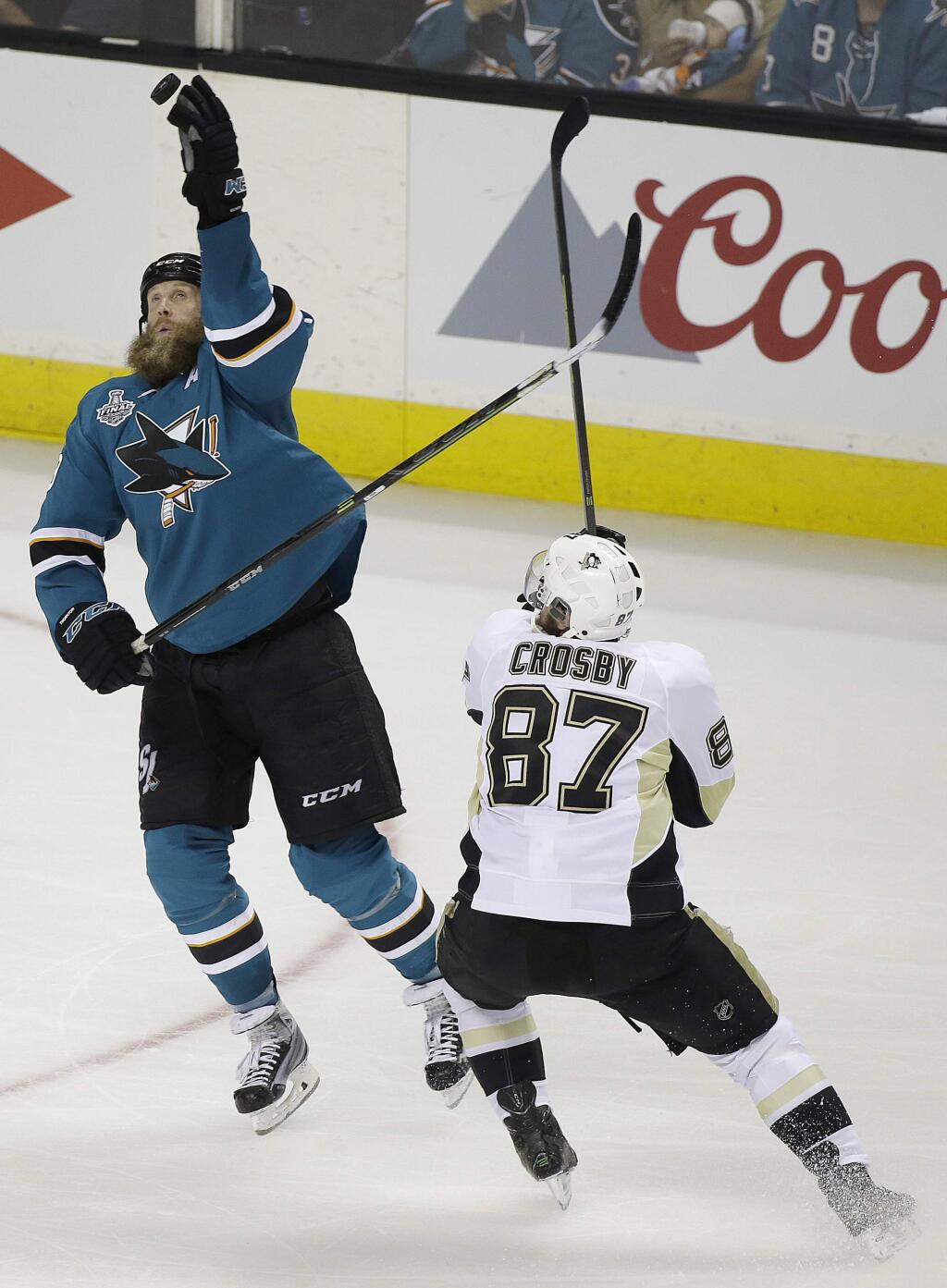 San Jose Sharks center Joe Thornton, left, reaches for the puck next to Pittsburgh Penguins center Sidney Crosby (87) during the second period of Game 3 of the NHL hockey Stanley Cup Finals in San Jose, Calif., Saturday, June 4, 2016. (AP Photo/Eric Risberg)