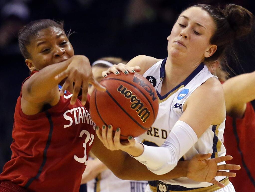Stanford guard Amber Orrange (33) tries to knock the ball away from Notre Dame's Michaela Mabrey during the first half of a game in the NCAA tournament, Friday, March 27, 2015, in Oklahoma City. (AP Photo/Sue Ogrocki)