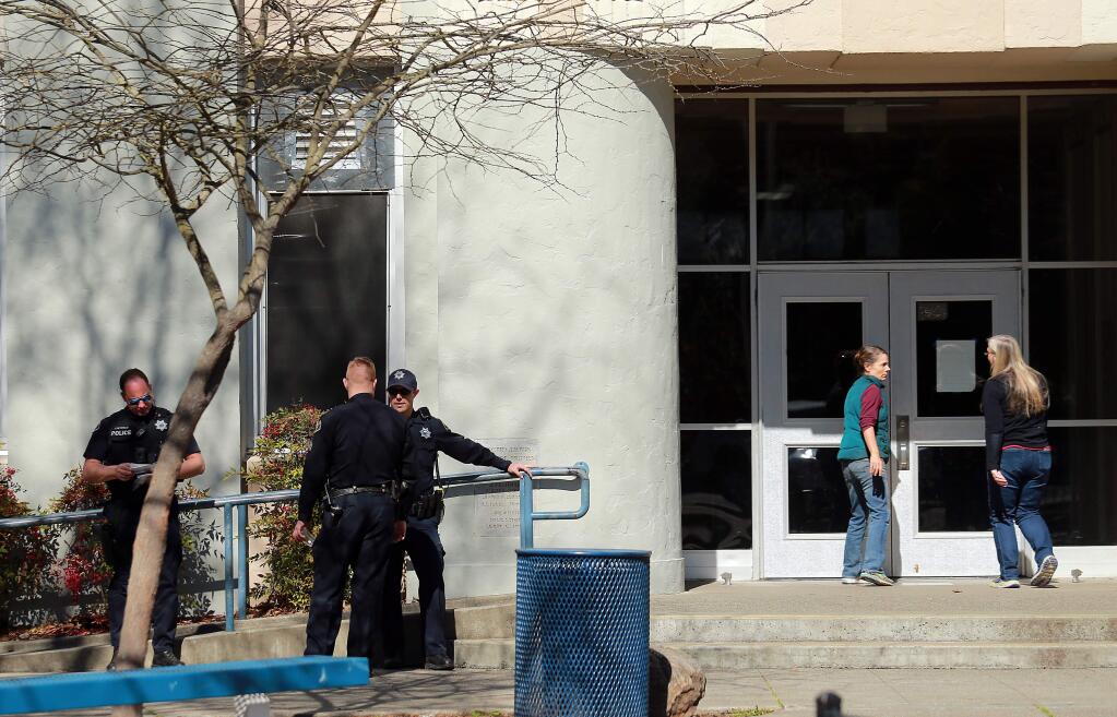 Sebastopol police officers stand in the front of Analy High School on Tuesday afternoon after students were evacuated when graffiti was found at the school threatening violence. (John Burgess/The Press Democrat)
