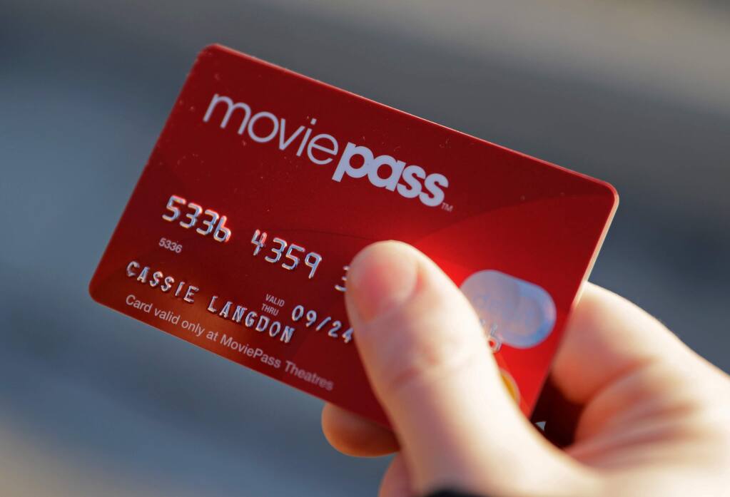 FILE - In this Jan. 30, 2018, file photo, Cassie Langdon holds her MoviePass card outside AMC Indianapolis 17 theatre in Indianapolis. MoviePass, Inc. was an American subscription-based ticket service headquartered in New York City. Founded in 2011, the service initially allowed subscribers to purchase up to three movie tickets per month for a discounted monthly fee. AP Photo/Darron Cummings, File)