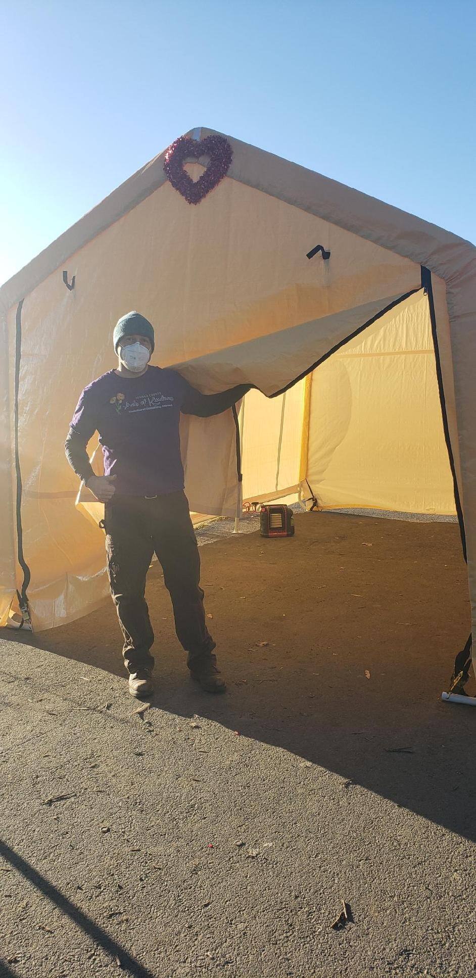 Miles Sarvis-Wilburn, 35, co-founder of the Squeaky Wheel Bicycle Coalition stands with one of the heated tents his organization has set up to help the homeless through the freezing temperatures.