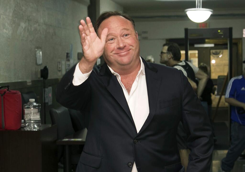 FILE - In this April 19, 2017, file photo, Alex Jones, a right-wing radio host and conspiracy theorist, arrives at the courthouse in Austin, Texas. Twitter says it is suspending the account of the far-right conspiracy theorist Alex Jones for one week after he violated the company's rules against inciting violence. (Jay Janner/Austin American-Statesman via AP, File)
