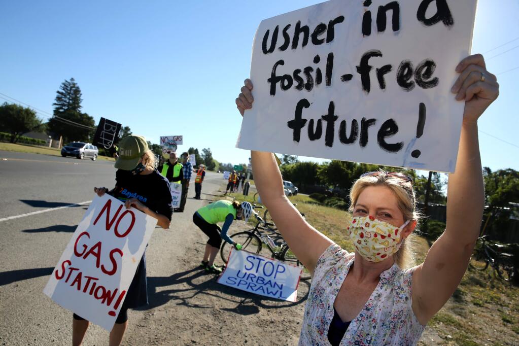 Nell Hergenrather joins with others organized by group CONGAS on Thursday, June 18, 2020, to protest a proposed gas station at the corner of Highway 12 and Llano Rd in unincorporated Sonoma County west of Santa Rosa, California. (BETH SCHLANKER/ The Press Democrat)