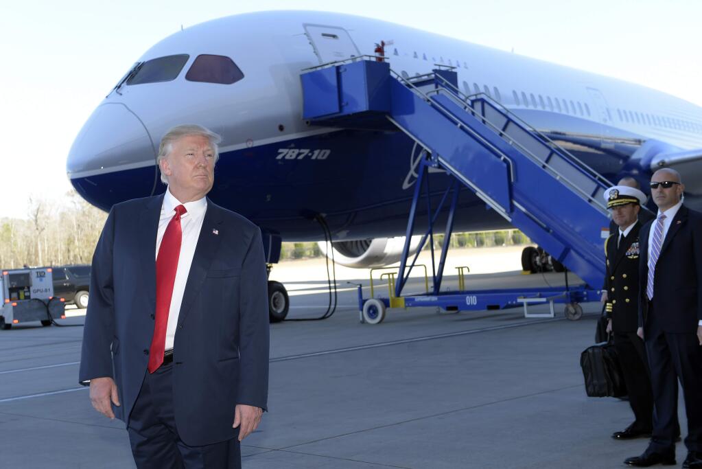 President Donald Trump stands in front of a Boeing 787 Dreamliner while visiting the Boeing South Carolina facility in North Charleston, S.C., Friday, Feb. 17, 2017. Trump visited the palnt before heading to his Mar-a-Lago estate in Palm Beach, Fla. for the weekend. (AP Photo/Susan Walsh)