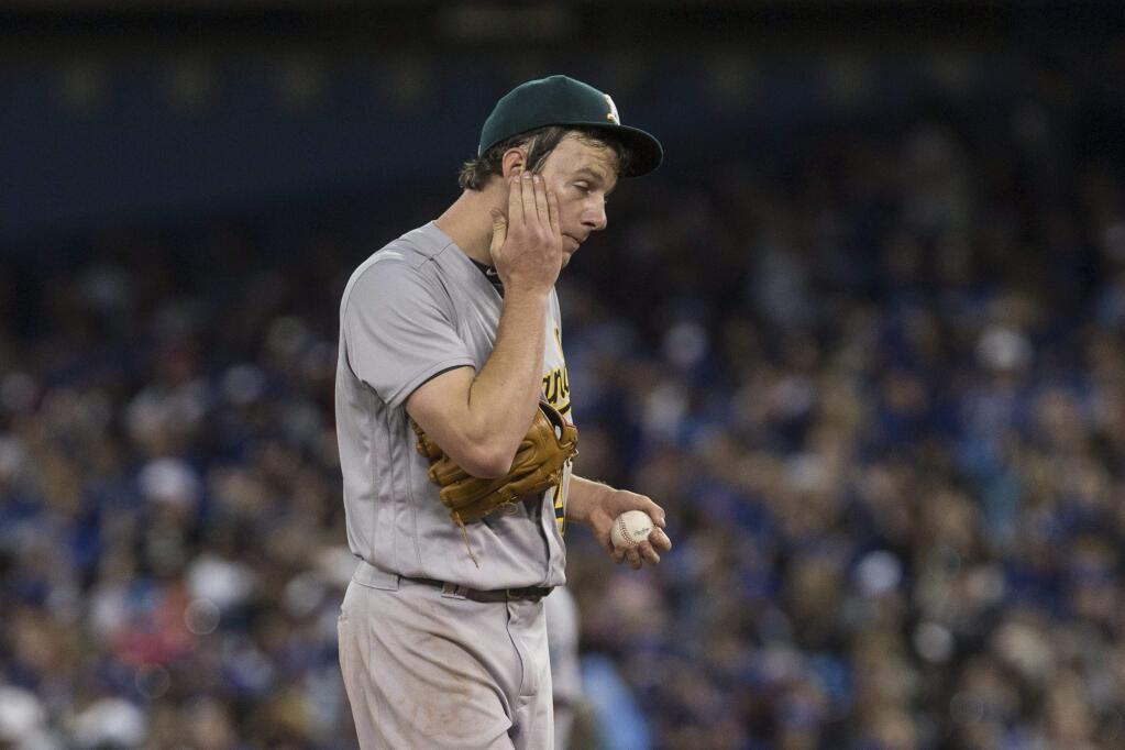 Oakland Athletics starting pitcher Chris Bassitt reacts during the second inning against the Toronto Blue Jays in Toronto on Saturday, April 23, 2016. (Chris Young/The Canadian Press via AP)