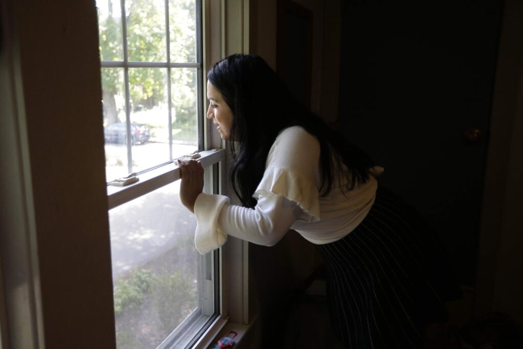 In this Wednesday, Aug. 30, 2017, photo, Ninotska Love, who has been accepted at Wellesley College, looks out a window in her dorm room at the women's school in Wellesley, Mass. A growing number of women's colleges are welcoming transgender women on campus after refusing to admit them for years. Two trans women, including Ninotska, attending Wellesley this fall are believed to be the first at the school since it decided to start allowing trans women in 2015. (AP Photo/Steven Senne)