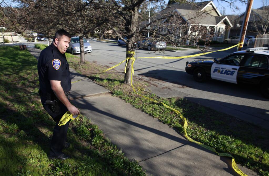 Santa Rosa Police Officer Rick Boehm secures the scene of an attempted robbery at a home on Acacia Lane in Santa Rosa on Monday, Feb. 23, 2015. (BETH SCHLANKER / PD FILE)