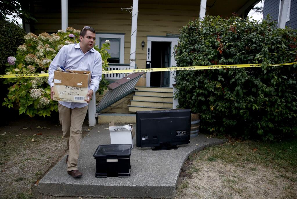 Austin Gallion helps to remove the belongings of his friend Sarah Sandbek from her apartment on 4th Street after it was severely damaged during a 6.0 earthquake on Sunday, August 24, 2014 in Napa, California. (BETH SCHLANKER/ The Press Democrat)