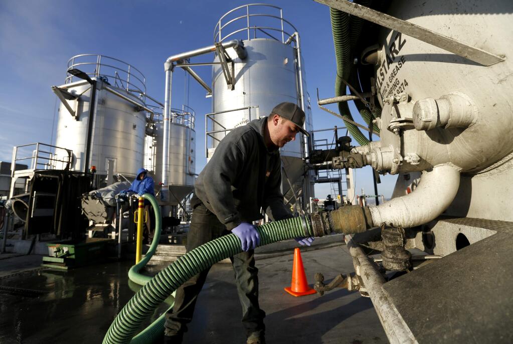 Ken Kolp of North Bay Restaurant Services hooks up a hose to transfer septic tank sludge from his truck to a high strength waste system at the Laguna Treatment Plant in Santa Rosa, on Tuesday, December 20, 2016. (BETH SCHLANKER/ The Press Democrat)