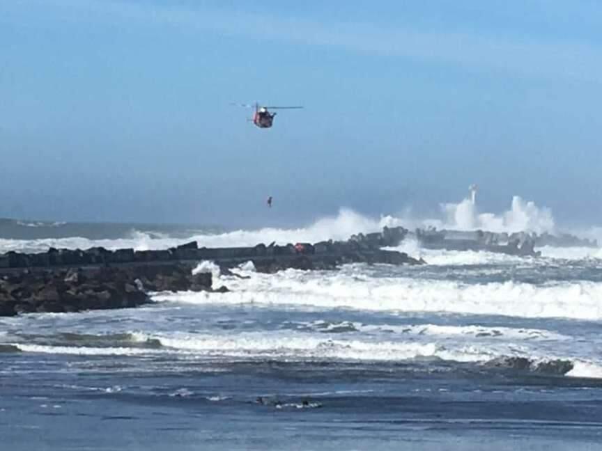 The U.S. Coast Guard rescued a driver trapped in high surf from Humboldt Bay's north jetty on Thursday, Jan. 26, 2017. (U.S. COAST GUARD)