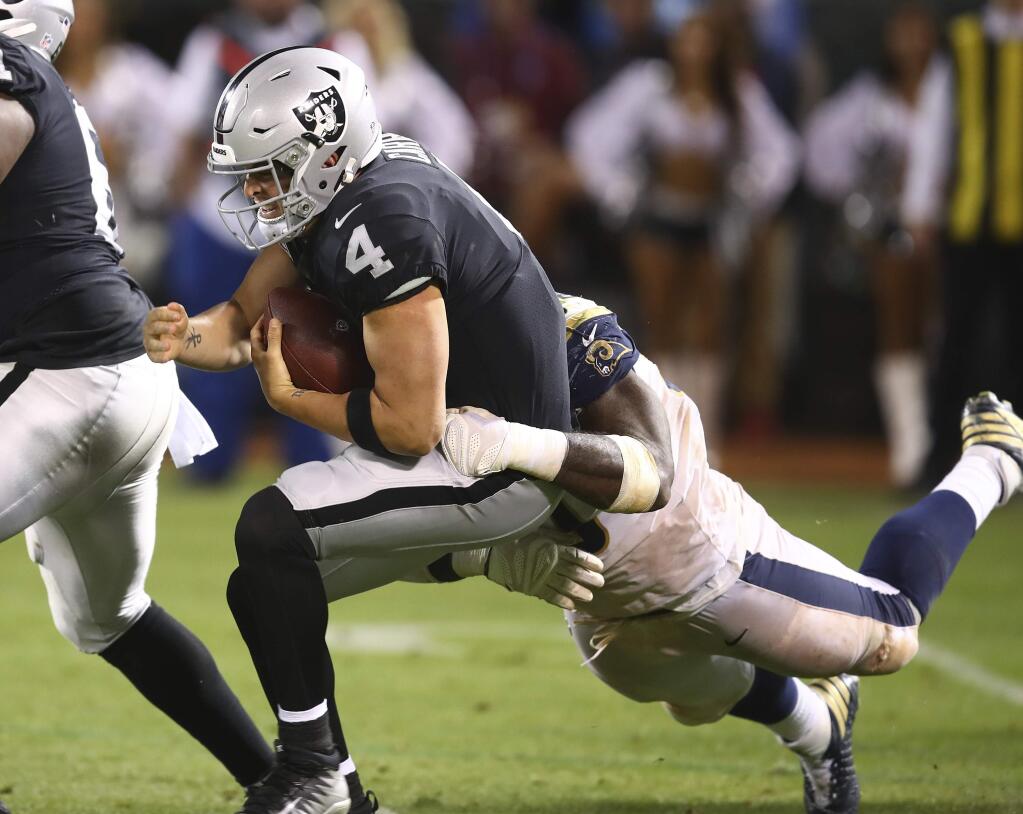 Oakland Raiders quarterback Derek Carr is sacked by Los Angeles Rams defensive tackle Michael Brockers during the second half in Oakland, Monday, Sept. 10, 2018. (AP Photo/Ben Margot)
