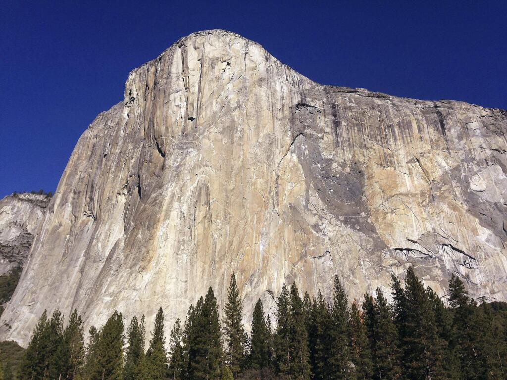FILE - This Jan. 14, 2015 file photo shows El Capitan in Yosemite National Park, Calif. An elite rock climber has become the first to climb alone to the top of the massive granite wall in Yosemite National Park without ropes or safety gear. National Geographic documented Alex Honnold's historic ascent of El Capitan on Saturday, June 3, 2017, saying the 31-year-old completed the 'free solo' climb Saturday in nearly four hours. (AP Photo/Ben Margot, File)