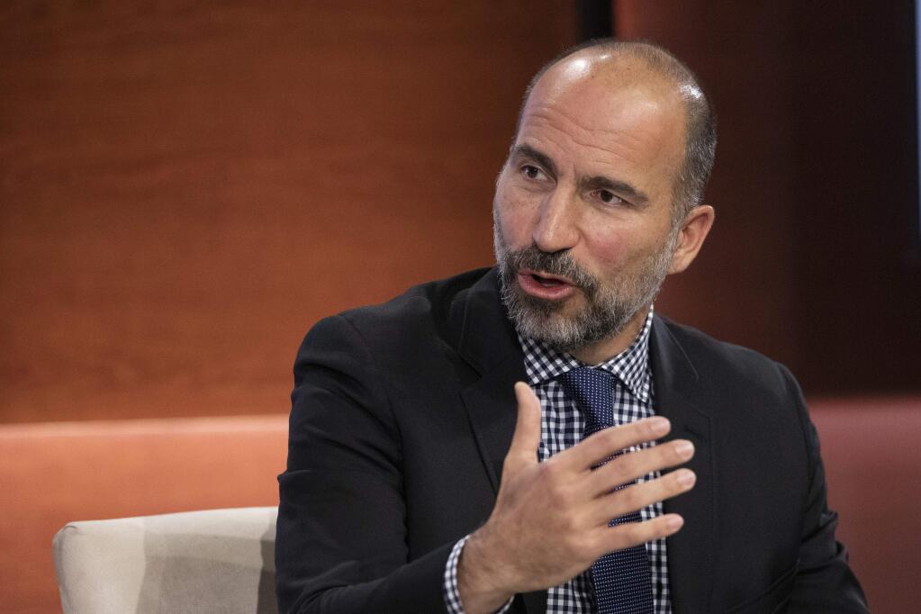 FILE - In this Wednesday, Sept. 25, 2019, file photo Dara Khosrowshahi, CEO of Uber, speaks at the Bloomberg Global Business Forum in New York. Uber will begin cramming more services into its ride-hailing app as it explores ways to generate more revenue and finally turn a profit. The makeover announced Thursday, Sept. 26, will include force-feeding its food delivery service, 'Eats,' into the Uber app that millions of people use to summon a ride. (AP Photo/Mark Lennihan, File)