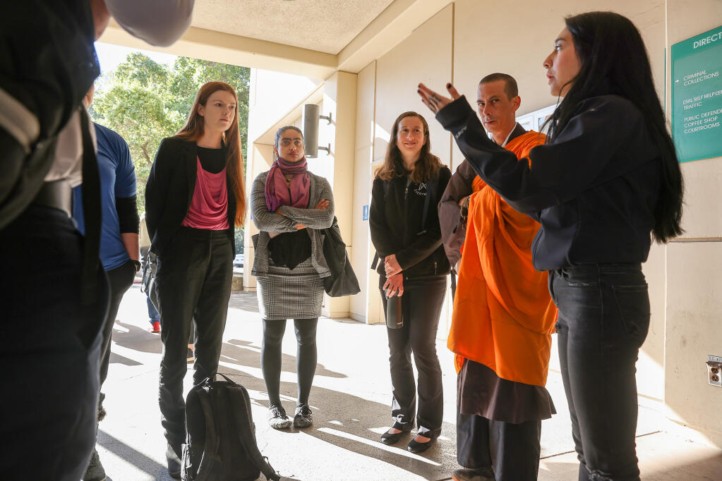 Animal welfare activists Cassandra King, left, Priya Sawhney, and Almira Tanner meet with supporters Robert Yamada and Michelle Del Curto before entering Sonoma County Superior Court for their hearing in Santa Rosa, Tuesday, Nov. 15, 2022. (Christopher Chung / The Press Democrat file)