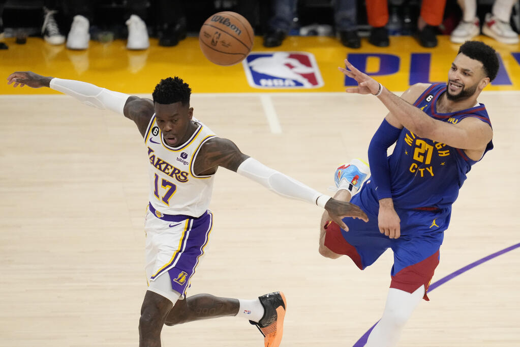 Denver Nuggets guard Jamal Murray, right, passes over Lakers guard Dennis Schroder in the second half of Game 3 of the Western Conference Final series Saturday, May 20, 2023, in Los Angeles. (Ashley Landis / ASSOCIATED PRESS)