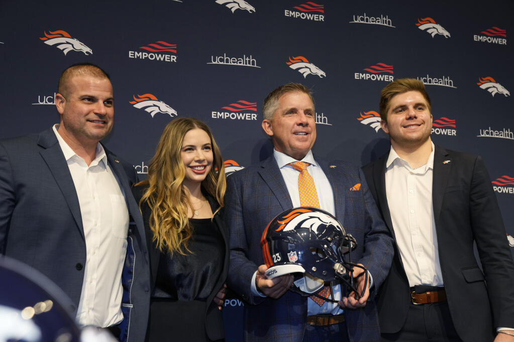 Newly-named Denver Broncos head coach Sean Payton, third from left, is joined, from left, by his future son-in-law, Chris Titone, daughter Meghan and son Connor for a photograph after an introductory news conference at the team's headquarters Monday, Feb. 6, 2023, in Centennial, Colo. (AP Photo/David Zalubowski)
