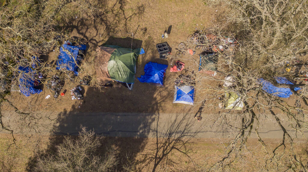 The Sonoma County Board of Supervisors, in an emergency $3 million move, is set to approve the establishment of two yearlong sanctioned camps for homeless individuals, at the Santa Rosa Veterans Memorial Building campus and on its own administrative campus in north Santa Rosa, to help clear and clean up the latest in a series of periodic homeless camps on the county-owned Joe Rodota Trail in west Santa Rosa. The move comes amid sustained pressure from cycling interests spotlighting obstructions on trail use due to occupation by homeless individuals. A dozen campsites are stung along the trail at Brittain Lane just off of Highway 12 in Santa Rosa, Monday, Feb. 20, 2023. (Chad Surmick / The Press Democrat)
