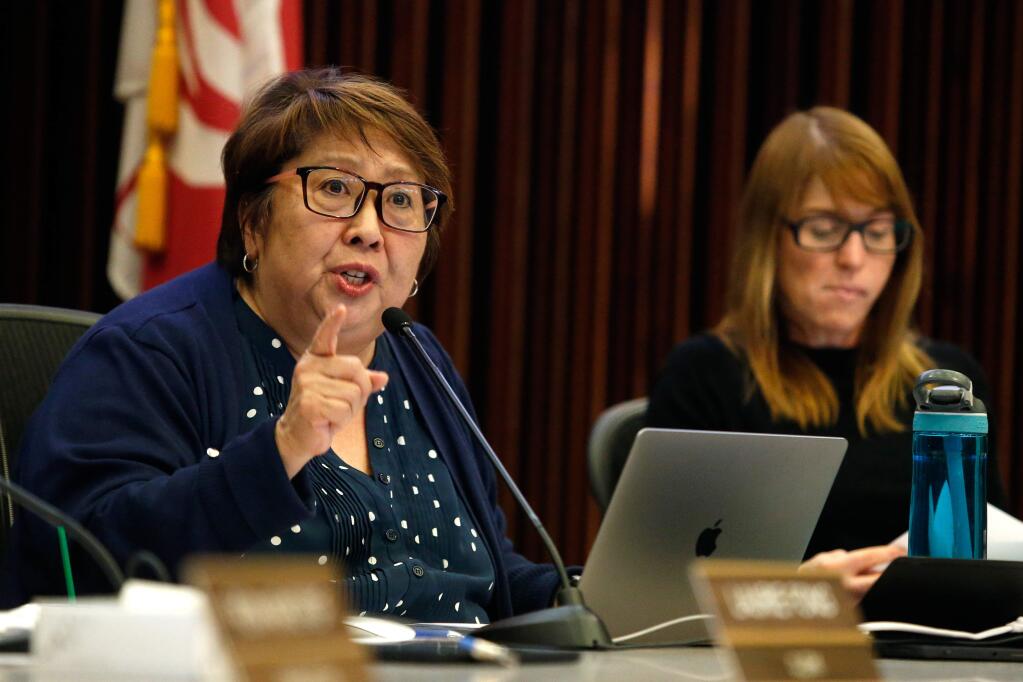 Santa Rosa City Schools superintendent Dianna Kitamura, left, speaks about a plan to incorporate a program requiring high school students to take college preparatory classes in order to graduate, during a school board meeting at city hall in Santa Rosa, California, on Wednesday, April 25, 2018. (ALVIN JORNADA/ PD)