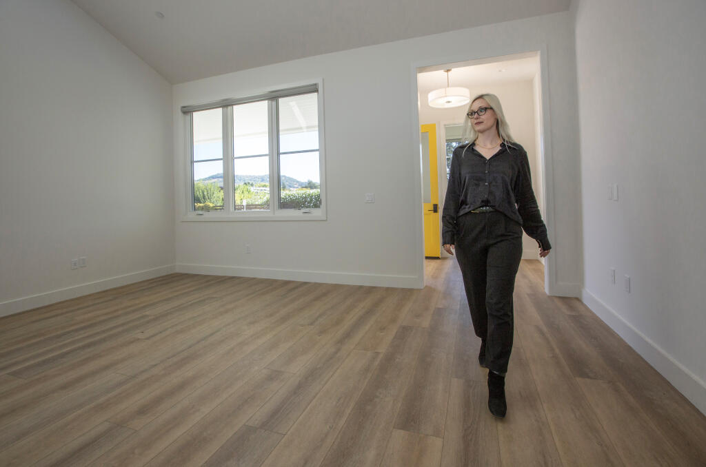 On Oct. 5, 2023, Olivia Vain, executive director of Sweetwater Spectrum, walks through the recently completed residential building, where every element is designed to consider those with autism and sensory disorders.  (Robbi Pengelly/Index-Tribune)