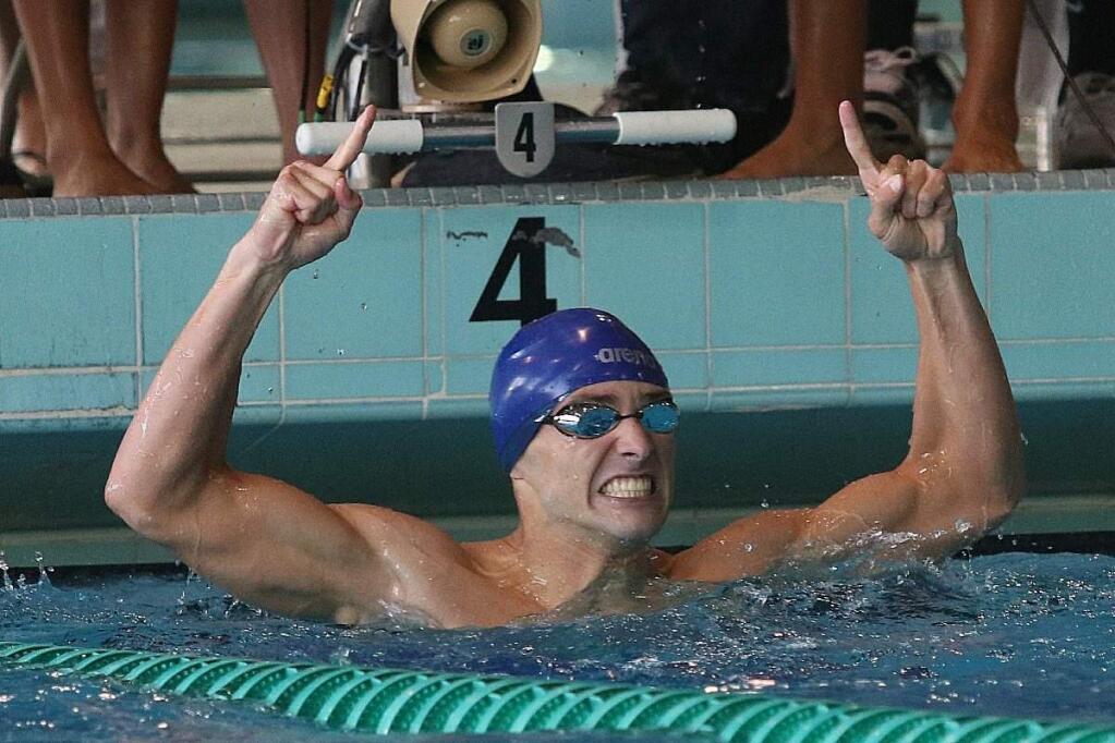 SRJC swimmer R.J. Williams raises his index fingers after winning the 100-yard butterfly at the CCCAA state championships last weekend in Los Angeles. (Richard Quinton / CCCAA)