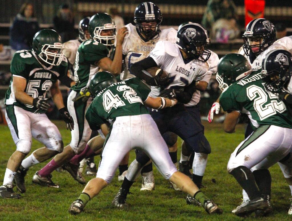 Bill Hoban/Index-TribuneSonoma's Louis Alvarez (53), David Grubb (37), Max Houghton (42) and Jesus Vazquez (25) converfe on an Elsie Allen ball carrier during Friday night's game. The Dragons beat Elsie, 48-20, for their third straight win.