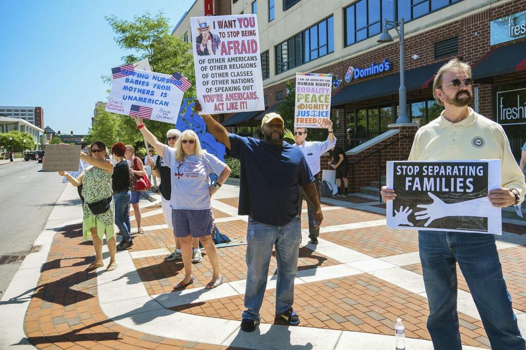 People line up to protest U.S. Attorney General Jeff Sessions and immigration reform at Parkview Field in Fort Wayne, Ind., Thursday, June 14, 2018. (Mike Moore/The Journal-Gazette via AP)