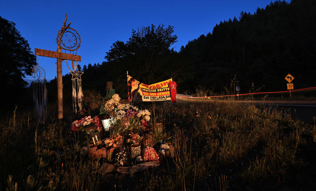 A poster for missing Khadijah Britton, a member of the Wailacki Round Valley Indian Tribe who was last seen pulled into a car at gunpoint in Covelo, is displayed, Tuesday, May 10, 2022, alongside the roadside memorial marker where Rachel Sloan's remains were discovered by hikers on May 16, 2013. Sloan was a member of Laytonville’s Cahto tribe. (Kent Porter/The Press Democrat)