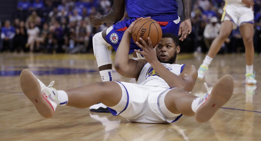 Golden State Warriors' Omari Spellman recovers a loose ball behind Los Angeles Clippers' JaMychal Green during the first half of an NBA basketball game Thursday, Oct. 24, 2019, in San Francisco. (AP Photo/Ben Margot)