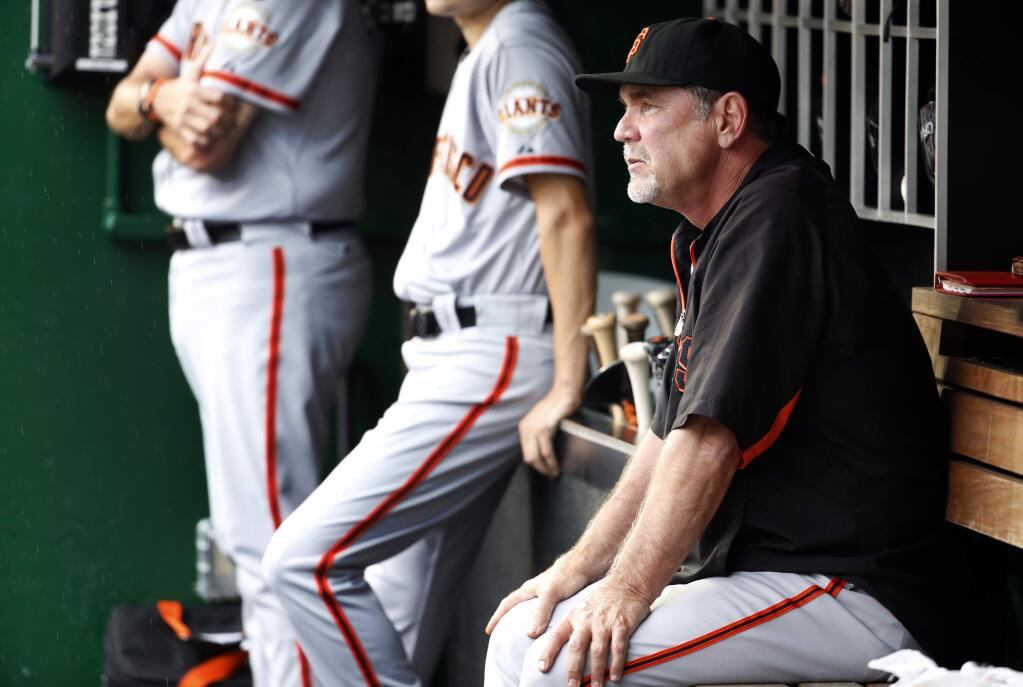 San Francisco Giants manager Bruce Bochy pauses in the dugout during a baseball game against the Washington Nationals at Nationals Park, Friday, July 3 in Washington. (AP Photo/Alex Brandon)