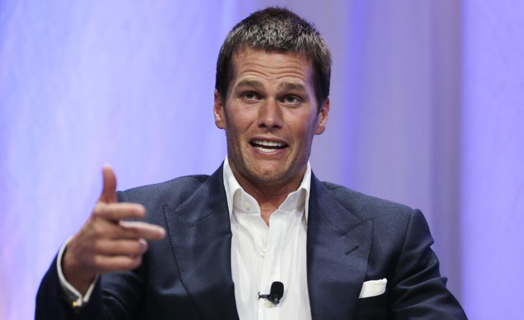 In a Thursday, May 7, 2015 file photo, New England Patriots quarterback Tom Brady gestures during an event at Salem State University in Salem, Mass. The NFL suspended Brady for the first four games on Monday, May 11, 2015, for his role in a scheme to deflate footballs used in the AFC title game. (AP Photo/Charles Krupa, Pool, File)