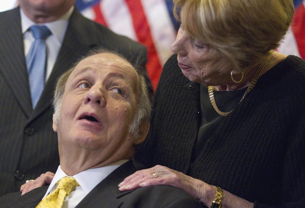 FILE - This March 30, 2011 file photo shows former White House press secretary James Brady, left, who was left paralyzed in the Reagan assassination attempt, looking at his wife Sarah Brady, during a news conference on Capitol Hill in Washington marking the 30th anniversary of the shooting. A Brady family spokeswoman says Brady has died at 73. (AP Photo/Evan Vucci)