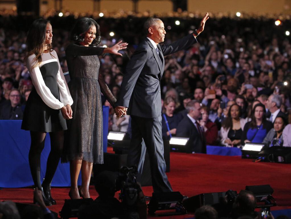 President Barack Obama waves as he is joined by First Lady Michelle Obama and daughter Malia Obama after giving his presidential farewell address at McCormick Place in Chicago, Tuesday, Jan. 10, 2017. (AP Photo/Nam Y. Huh)