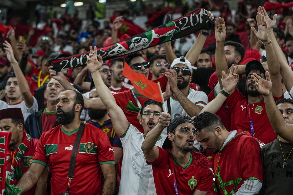 Morocco fans cheer before the World Cup quarterfinal soccer match between Morocco and Portugal, at Al Thumama Stadium in Doha, Qatar, Saturday, Dec. 10, 2022. (AP Photo/Ariel Schalit)