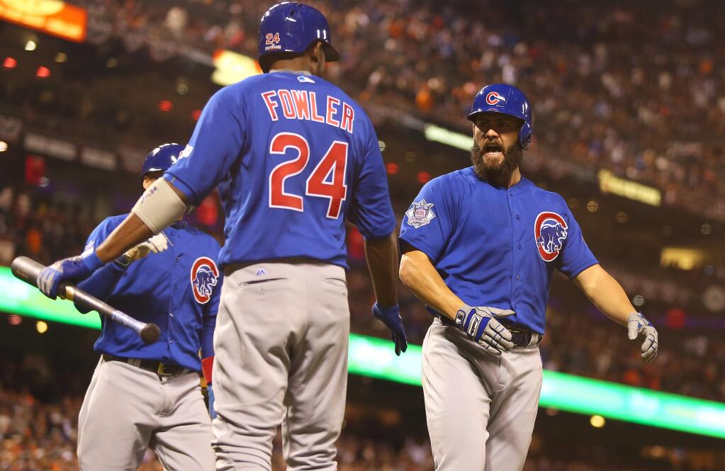 Chicago Cubs' Jake Arrieta, right, is met at the plate by teammates Dexter Fowler and Javier Baez, after hitting a three-run homer against the San Francisco Giants, during their game in San Francisco on Monday, October 10, 2016. (Christopher Chung/ The Press Democrat)