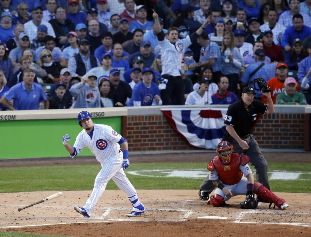 Chicago Cubs' Kyle Schwarber (12) watches the ball as he hits a home run against the St. Louis Cardinals during the second inning of Game 3 in baseball's National League Division Series, Monday, Oct. 12, 2015, in Chicago. (AP Photo/Charles Rex Arbogast)