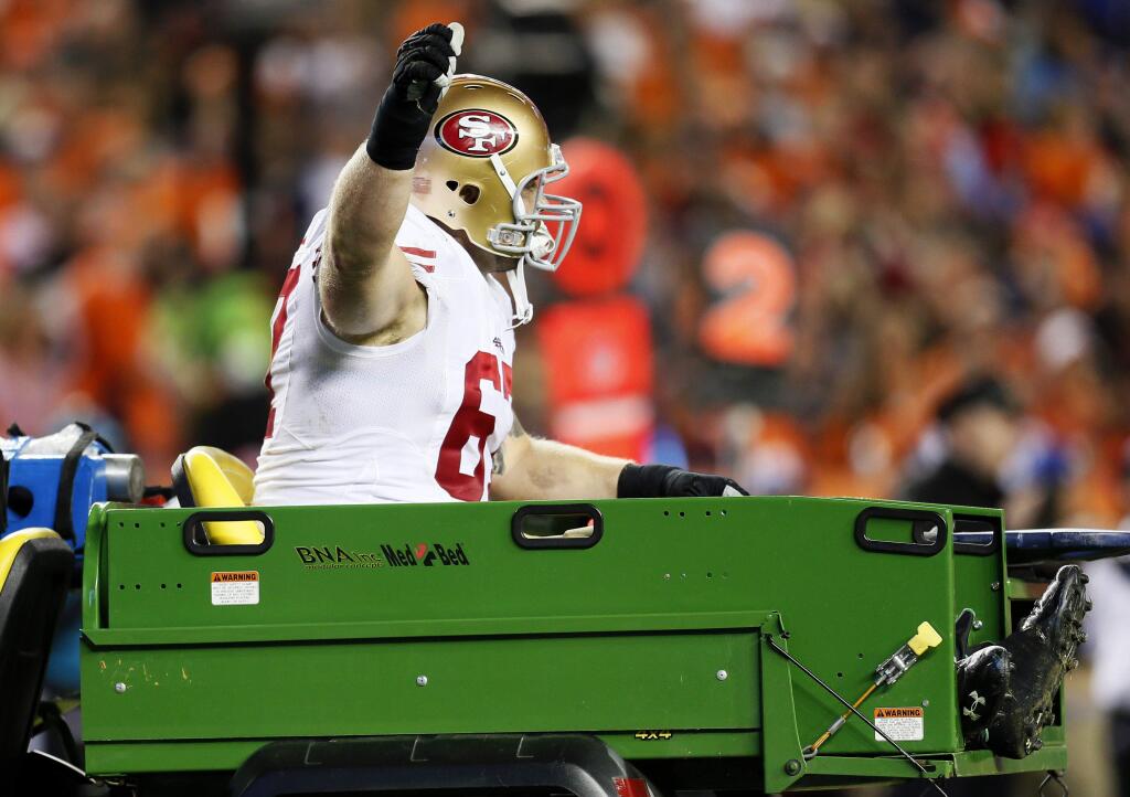 San Francisco 49ers center Daniel Kilgore gives the thumbs up as he is carted off the field against the Denver Broncos during the second half of an NFL football game, Sunday, Oct. 19, 2014, in Denver. (AP Photo/Joe Mahoney)