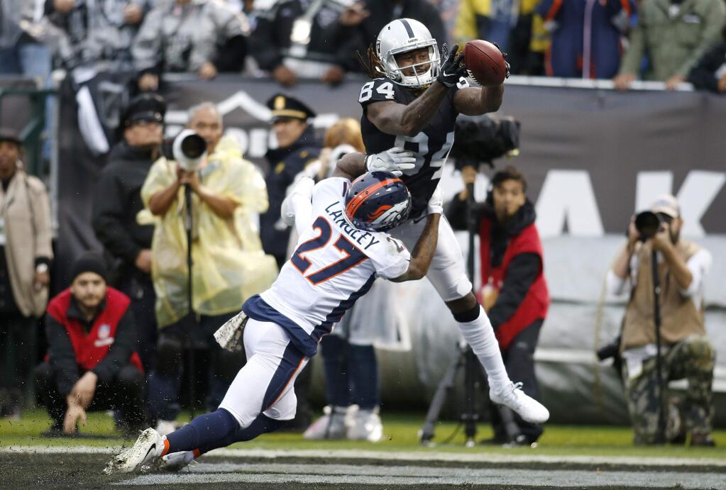 Broncos cornerback Brendan Langley (27) is called for pass interference on Oakland Raiders wide receiver Cordarrelle Patterson (84) during the first half Sunday, Nov. 26, 2017. (AP Photo/D. Ross Cameron)