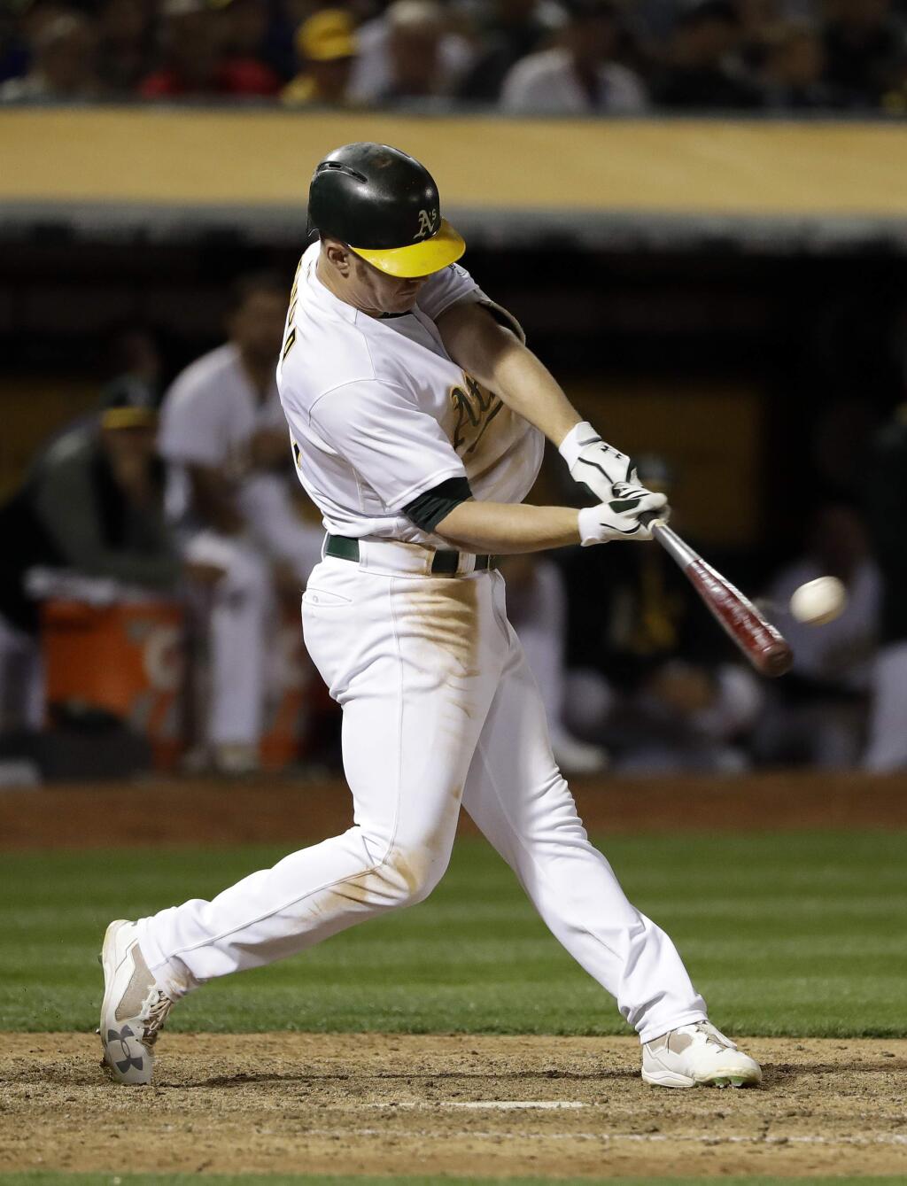 The Oakland Athletics' Mark Canha hits a solo walk-off home run during the 10th inning against the Boston Red Sox on Friday, May 19, 2017, in Oakland. (AP Photo/Marcio Jose Sanchez)