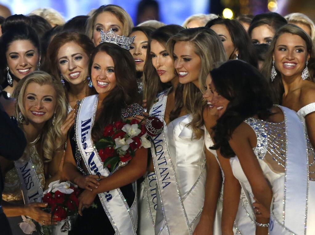 New Miss America Cara Mund, center left, with contestants during Miss America 2018 pageant, Sunday, Sept. 10, 2017, in Atlantic City, N.J. (AP Photo/Noah K. Murray)