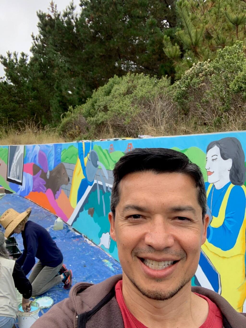 Steve Branton, financial adviser and principal at Private Ocean, stands in front of a mural he helped paint with other volunteers from the firm at the Marine Mammal Center in Sausalito in September 2019. (Private Ocean Photo)