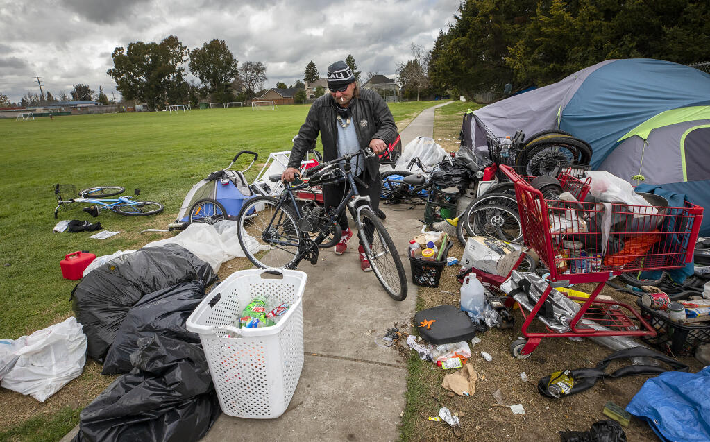 Don Hamberger packs up his belongings after the city of Santa Rosa announced they will clear the homeless encampment in Jennings Park in Santa Rosa on Tuesday, March 9, 2021. Hamberger says he will just find another place for his tent after a three month stay in the park. (John Burgess/The Press Democrat)