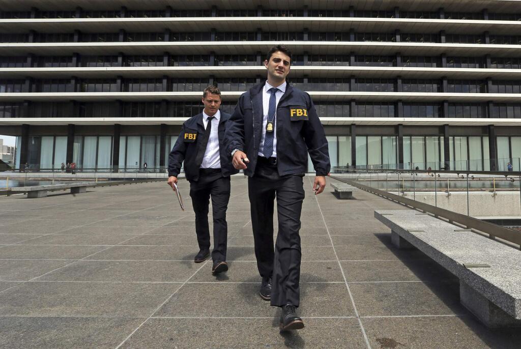 FBI agents leave the headquarters of the Los Angeles Department of Water and Power after spending several hours inside the building Monday, July 22, 2019. (AP Photo/Reed Saxon)