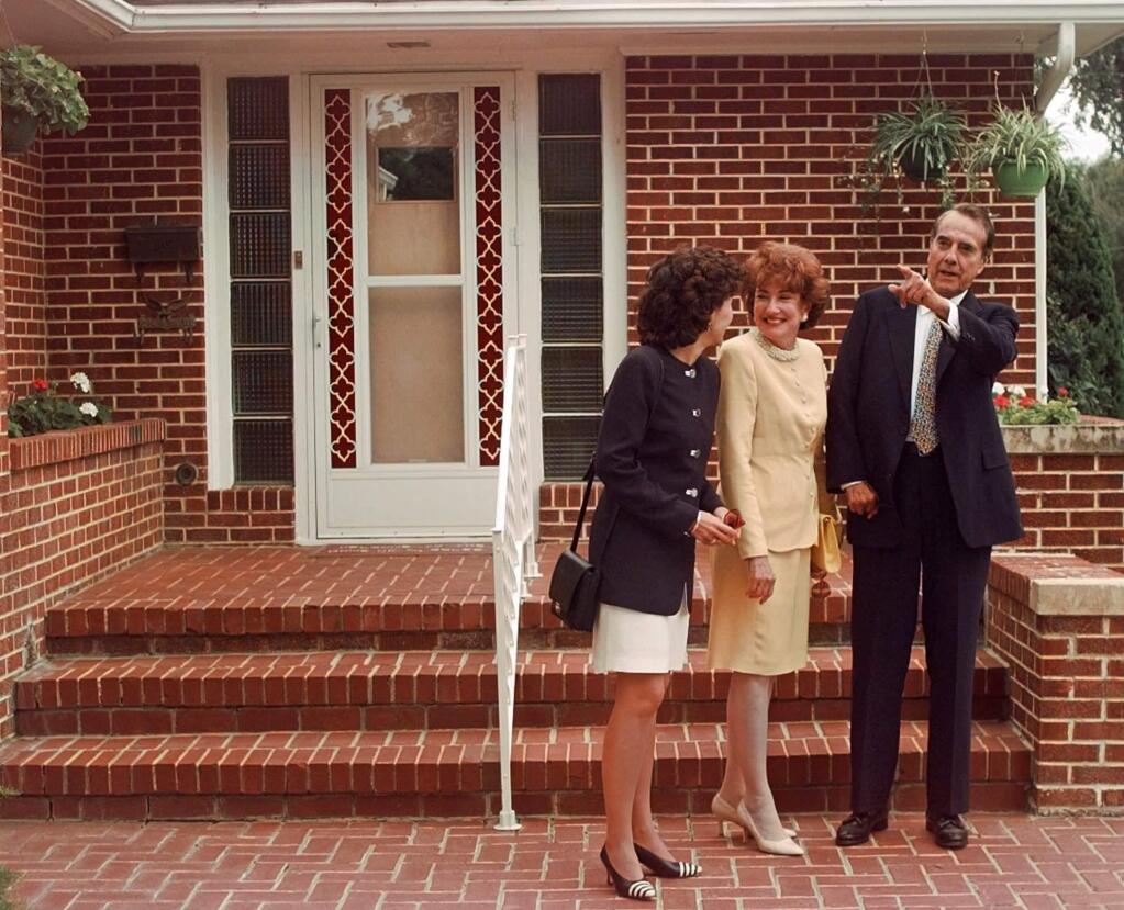 Bob Dole with his wife, Elizabeth, and their daughter Robin outside his boyhood home in Russell, Kansas. (STEVEN SAVOIA / Associated Press, 1996)