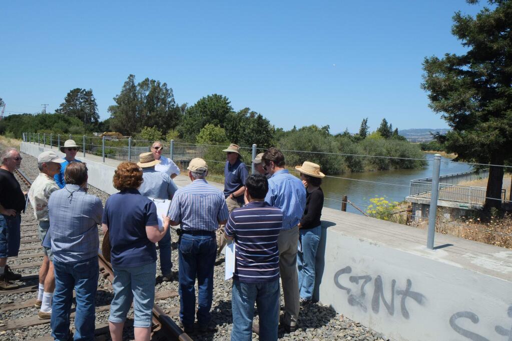 Erica Ahmann Smithies, senior civil engineer with the city of Petaluma, explains a project to reduce flood risk on a stretch of the Petaluma River during a field tour on Thursday, July 16, 2015. ERIC GNECKOW/ARGUS-COURIER STAFF
