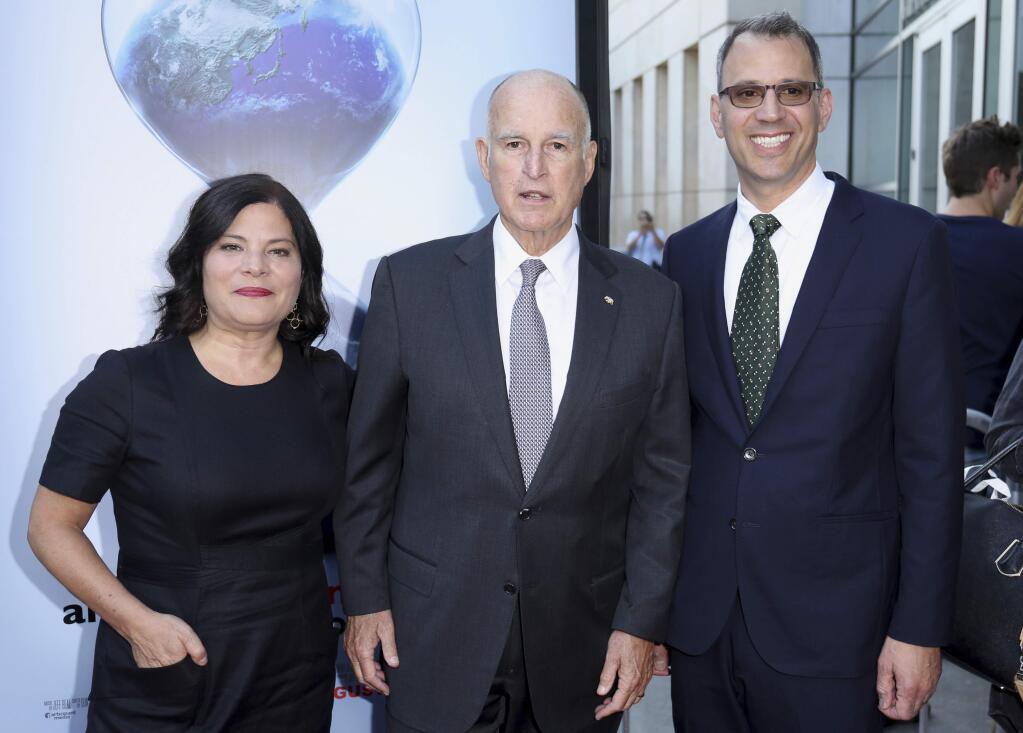 Bonni Cohen, from left, California Governor Jerry Brown and Jon Shenk arrive at the LA Premiere of 'An Inconvenient Sequel: Truth to Power' at the Arclight Hollywood on Tuesday, July 25, 2017, in Los Angeles. (Photo by Willy Sanjuan/Invision/AP)